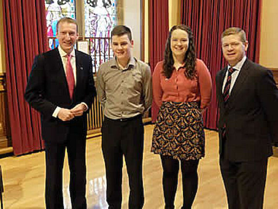 Kelvin and Kaylee with, on the left, Tavish Scott MSP and, on the right, Shetland Islands Council Convener, Malcolm Bell. (Courtesy Shetland Islands Council)