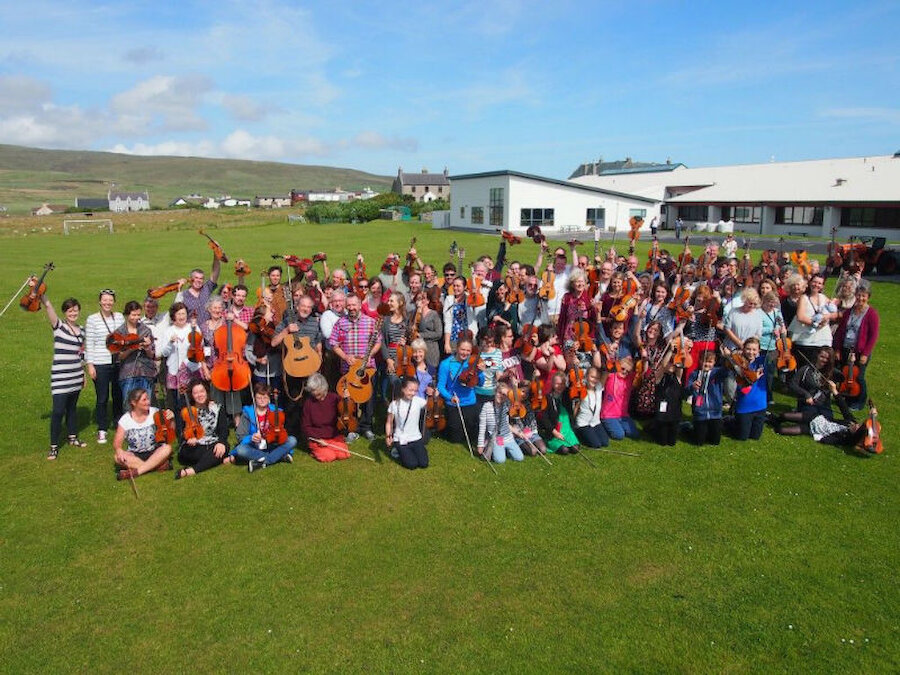 Fiddle Frenzy participants take a break in the Shetland sunshine. (Courtesy Shetland Arts)