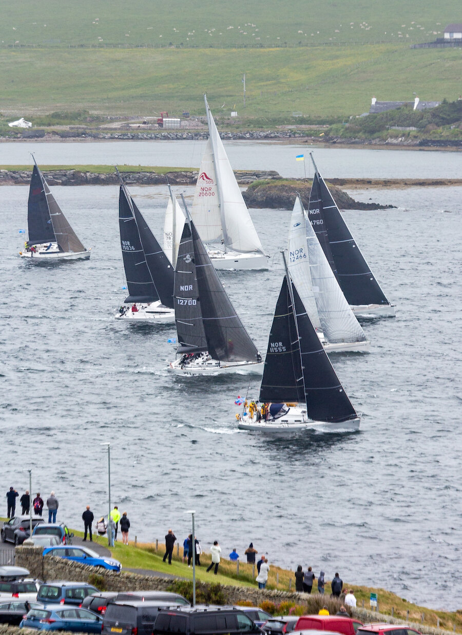 Spectators watch on from the shore as the yachts set off for the return leg to Norway on Sunday morning. Photo: Maurice Henderson.