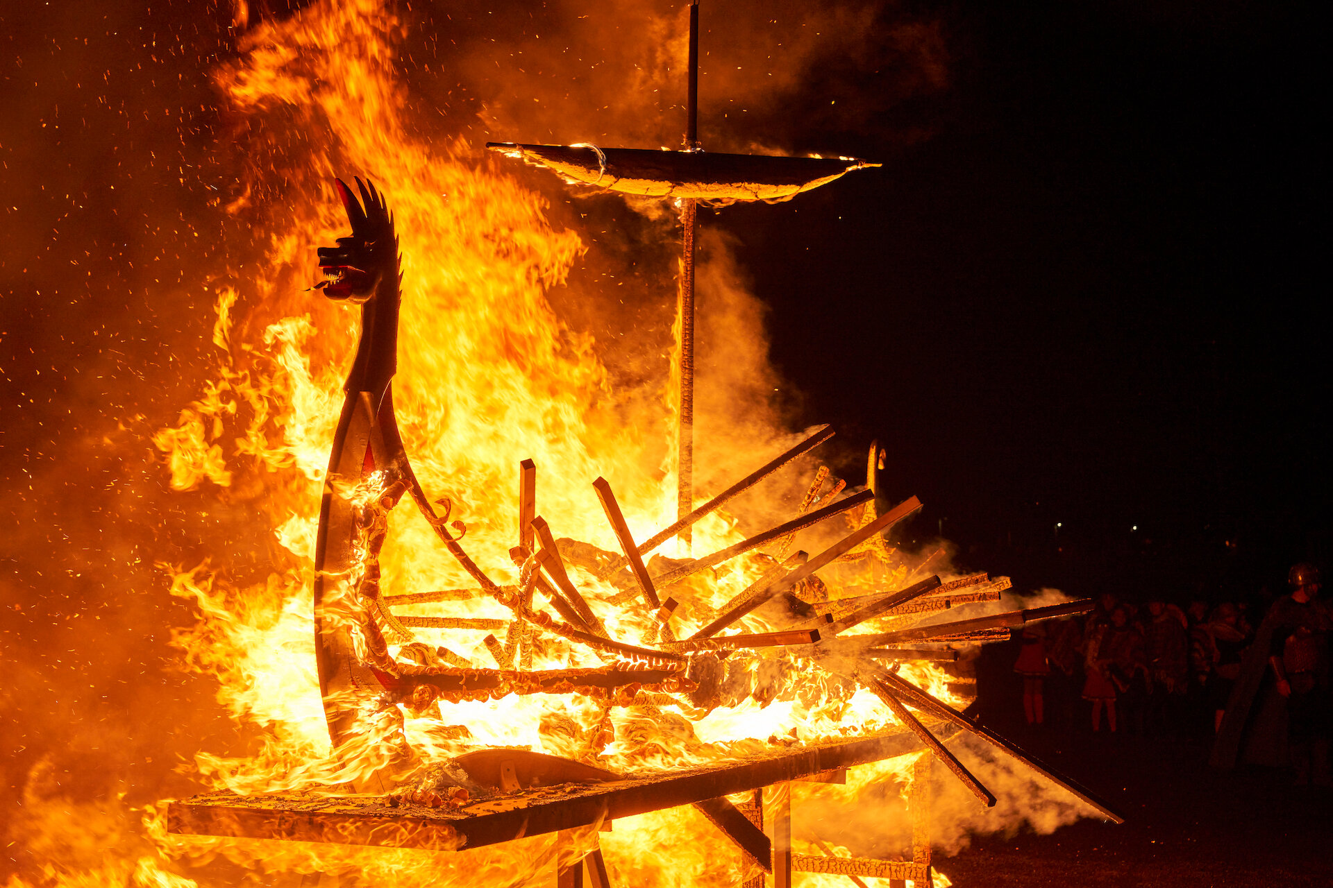 The procession culminates with guizers throwing their torches into a replica Viking longship and setting it ablaze. Photo: Euan Myles/Promote Shetland.