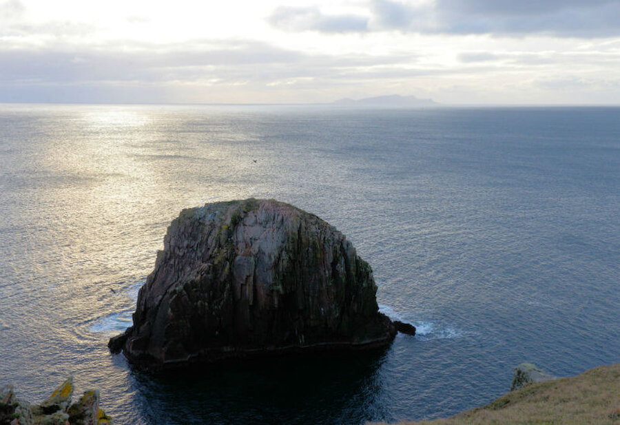 One of the stacks near Culswick broch, with Foula in the distance (Courtesy Alastair Hamilton)