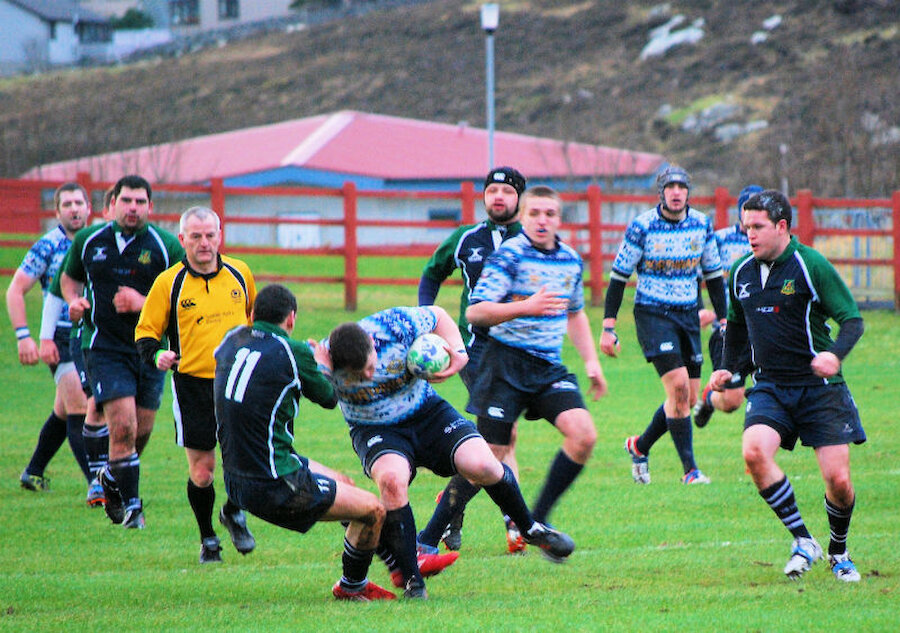 A Shetland player is tackled during a fixture at Clickimin (Courtesy Alastair Hamilton)
