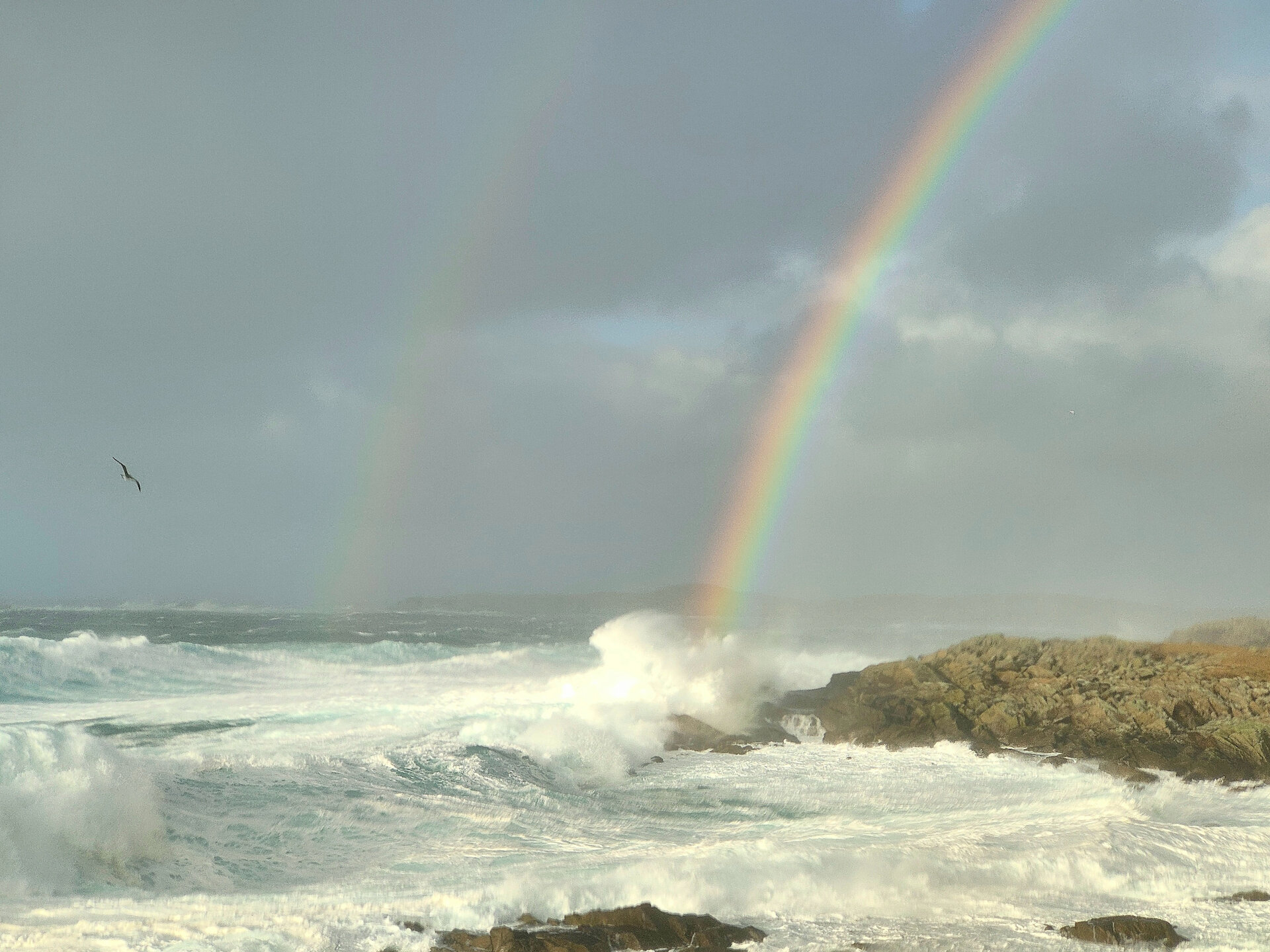 A rainbow rises above the stormy waves at Hamnavoe in Burra.