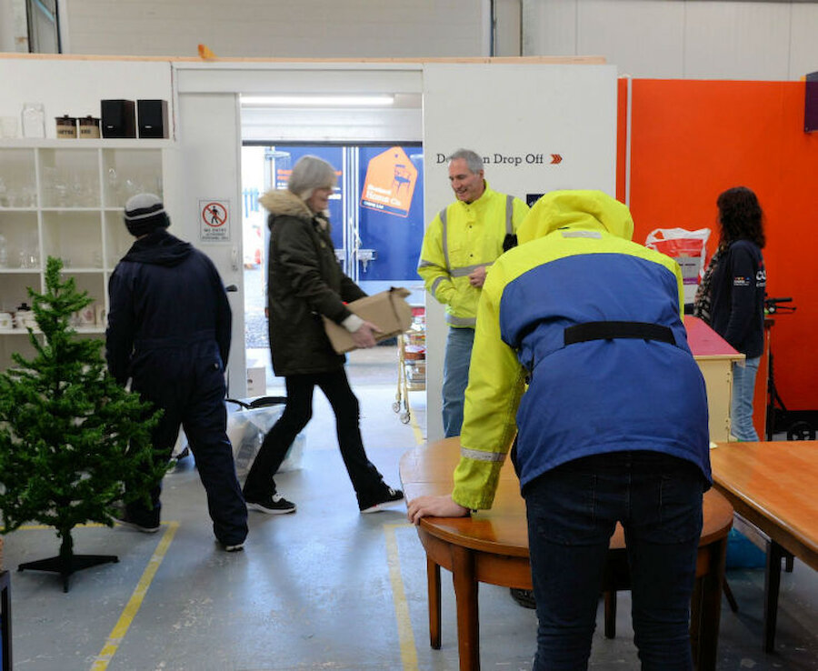 A table arrives by van while donors arrive with other goods (Courtesy Alastair Hamilton)