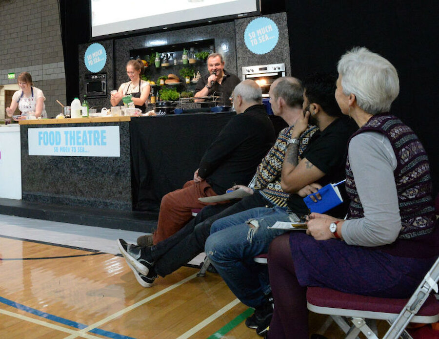 In the 2016 challenge, Jenny Fraser cooks, compere Davie Gardner keeps the conversation going and judges Dave Hammond, James Martin, Akshay Borges and Marion Armitage look on (Courtesy Alastair Hamilton)