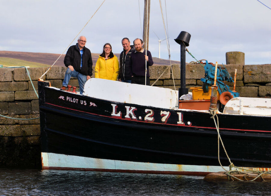 All aboard! The core organising team for the event gathers aboard the Pilot Us: (l-r) Brian Wishart, Emma Miller (Shetland Amenity Trust), John Henderson (Ocean Kinetics) and Ian Tait (Shetland Museum and Archives). Also on the team, but missing from the photo is Davy Cooper (Shetland Amenity Trust). (Courtesy Shetland Amenity Trust and Steven Christie)