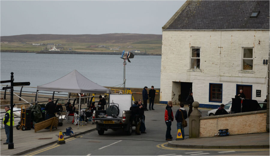 The cast and crew are seen here shooting a scene at the Small Boat Harbour in the heart of Lerwick.