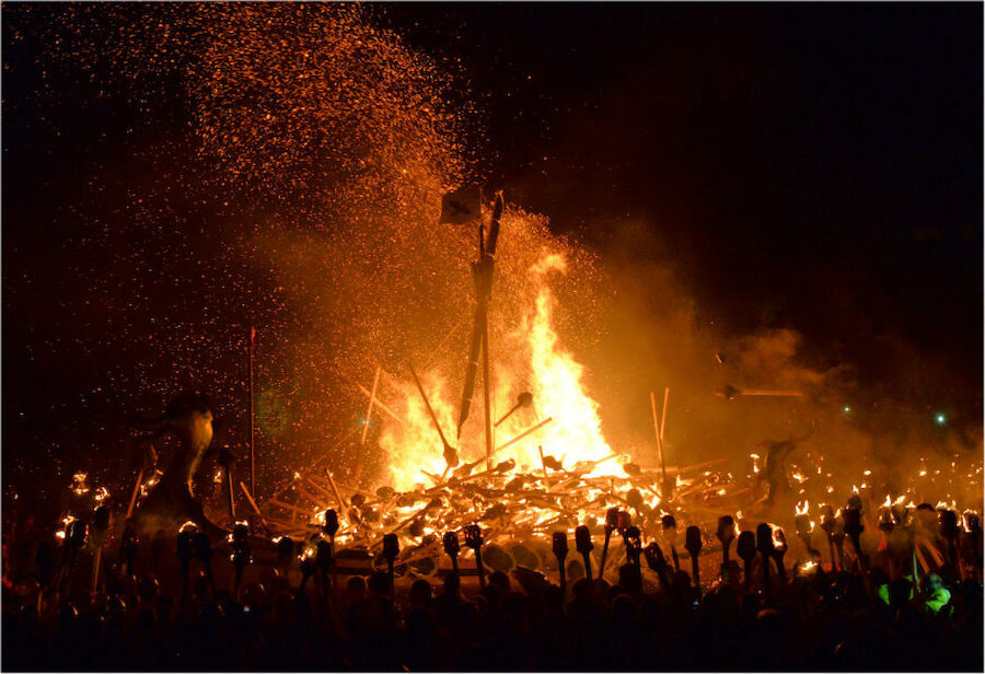 Sparks fly and the flames rise as more than 800 torches are thrown into the galley.