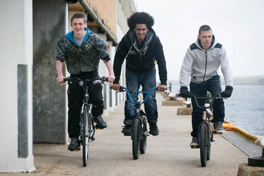 Three participants in the project go for a spin by the harbour (Courtesy Skills Development Scotland)