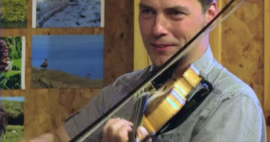 Fiddler Maurice Henderson, a member of Haltadans, in a scene from the video 'Foula Transit', available on the 'Back from Beyond' website. (Courtesy Haltadans/Back from Beyond)