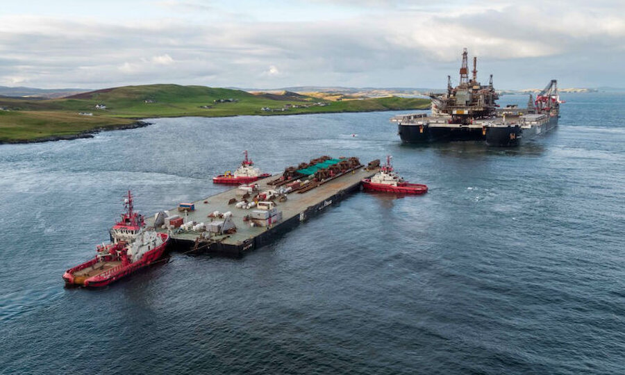 The barge, 'Iron Lady' is in the foreground, with the 'Pioneering Spirit' beyond (Courtesy Lerwick Port Authority/Rory Gillies/Shetland Flyer Aerial Media)
