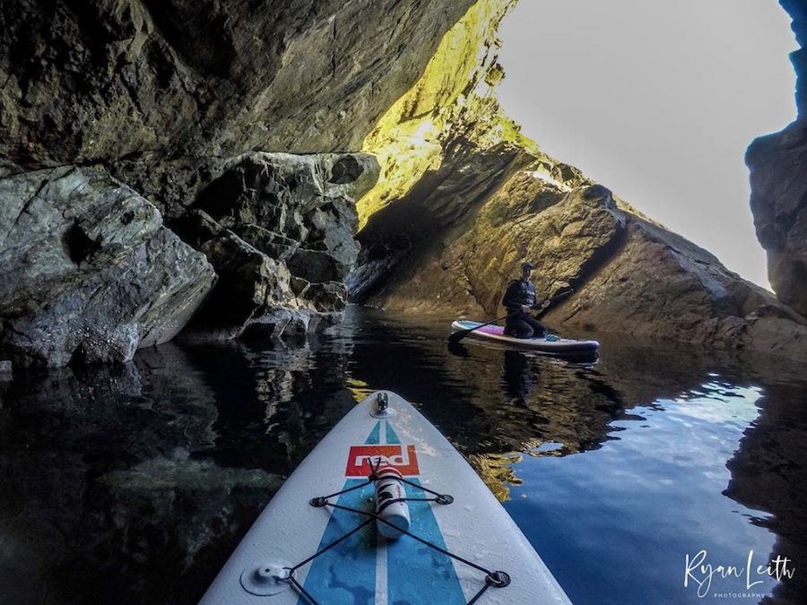 Exploring Lerwick's sea caves by paddleboard. Photo by Ryan Leith