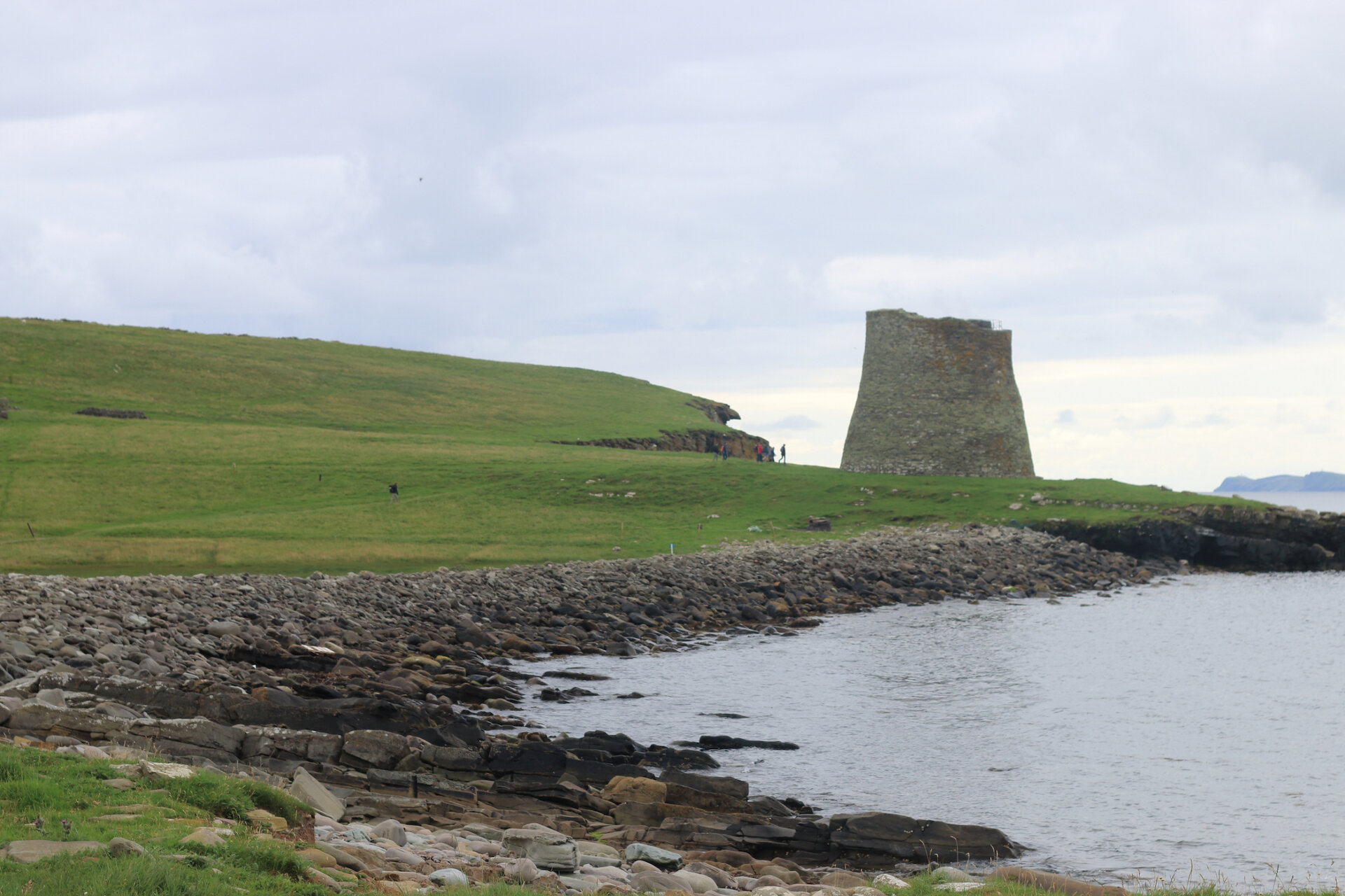 Mousa Broch and a replica Viking longship in Unst