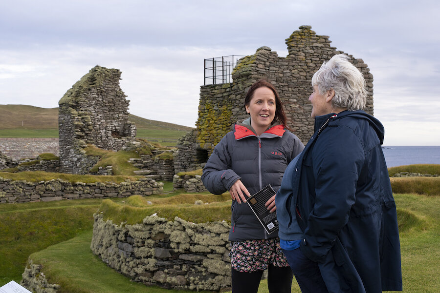 Laurie with a visitor on a tour of Jarlshof. Photo by Sophie Whitehead