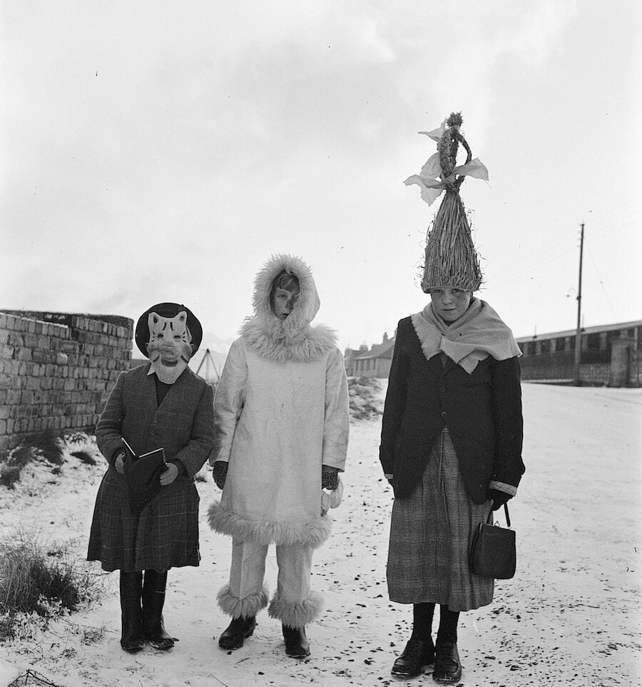 Three young guizers in Twageos road, Lerwick. L to R: David Scott, Ian McAlpine, Billy Sinclair. Sinclair is wearing a skeklers hat | Shetland Museum and Archives