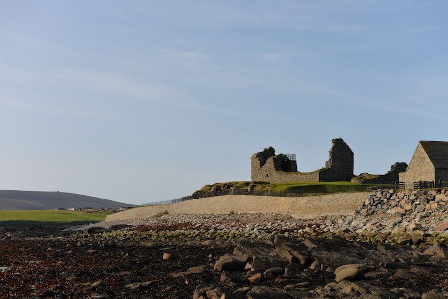 The archaeological site at Jarlshof is protected by a high sea wall. | Alastair Hamilton