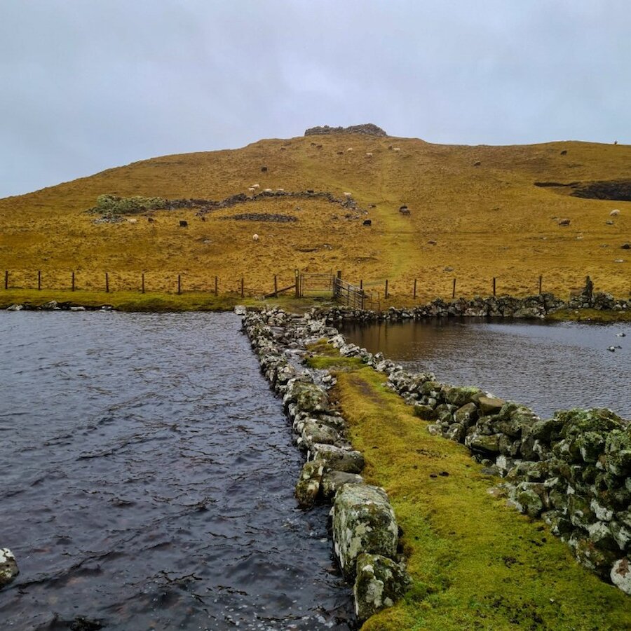 The causeway leading to Culswick Broch.