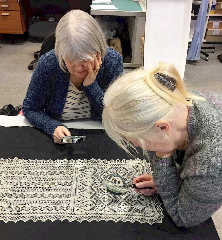 Kathleen Anderson and Anne Eunson examine one of the items in the museum's collection. | Shetland Museum and Archives