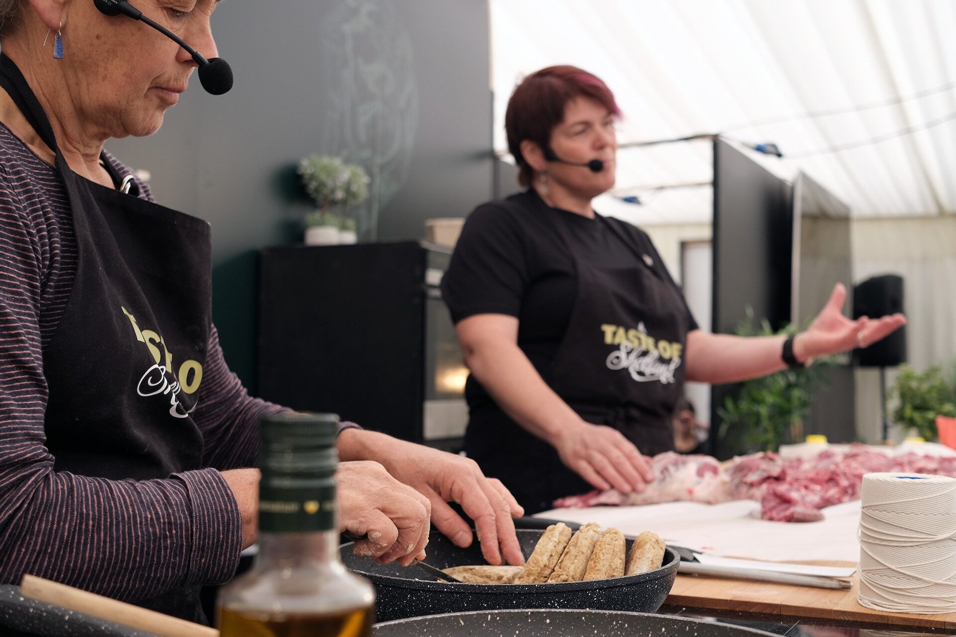 Marian Armitage and Lauraine Manson demonstrate how to debone a lamb without cutting it up into joints. Photo courtesy of Taste of Shetland.