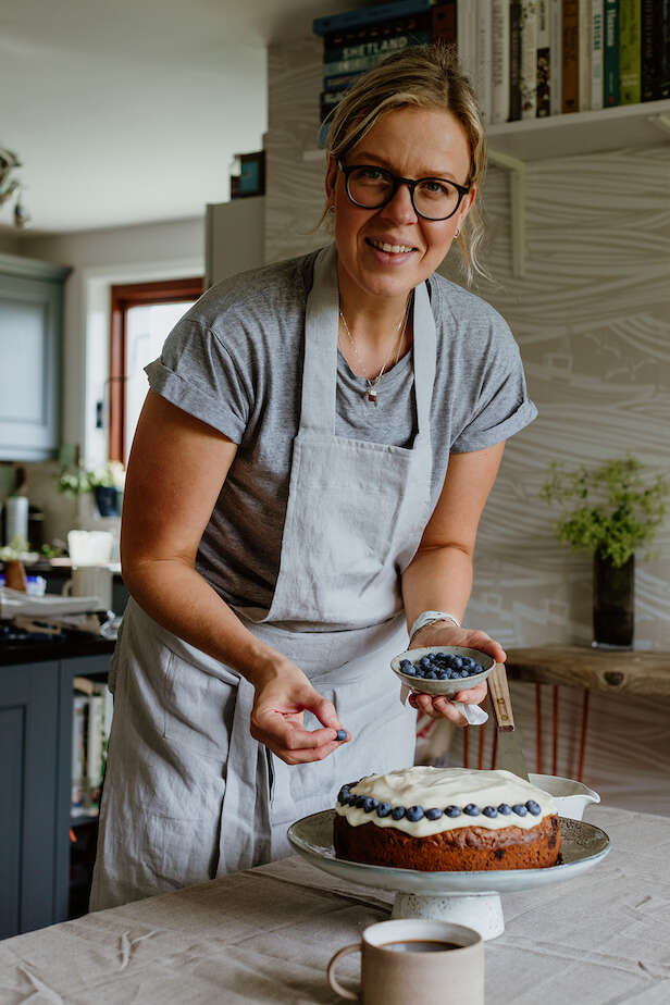 Misa Hay decorates her Carrot Cake with blueberries. Photo: Susan Molloy