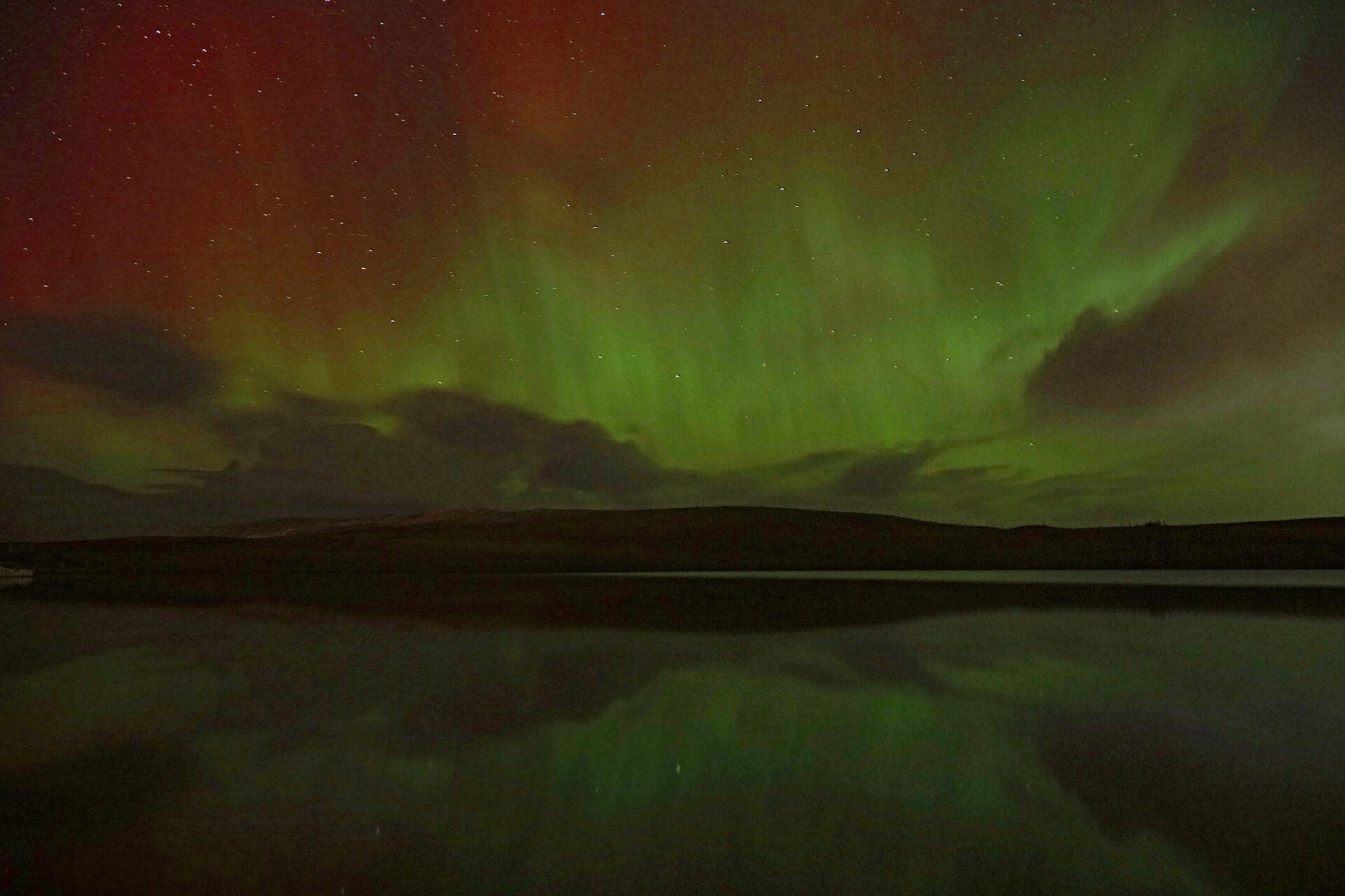 The northern lights reflected in a loch on a perfectly calm winter's evening.