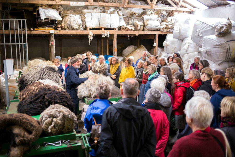 Oliver Henry, Patron of this year's Shetland Wool Week, gives a talk to visitors at a previous year's event (Courtesy Shetland Amenity Trust)