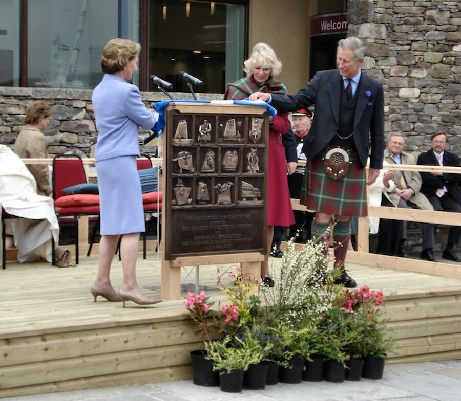 Mike McDonnell's bronze plaque celebrating the opening of the new Shetland Museum and Archives is unveiled by HM Queen Sonja of Norway and the Duke and Duchess of Rothesay. | Shetland Museum and Archives