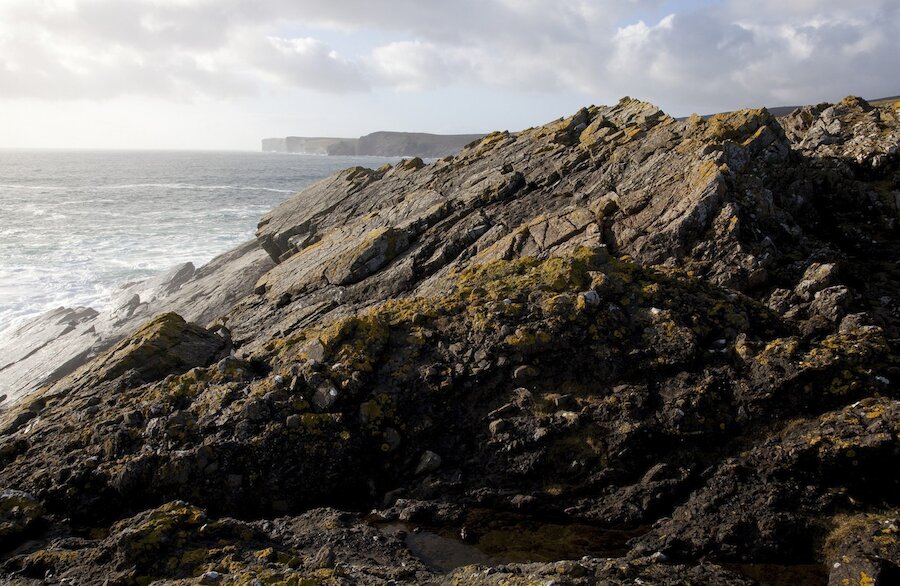 Breccia in the foreground at Muckle Hell vent with sandstone slabs beyond