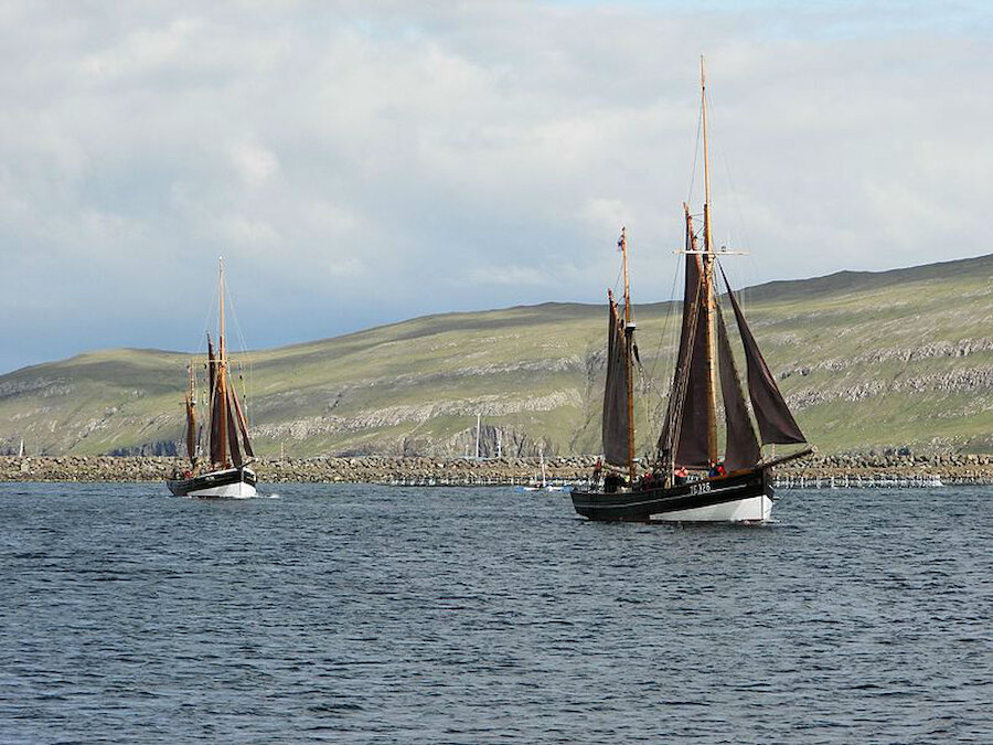 Two of the Faroese wooden vessels, 'Johanna' and 'Westward Ho' are seen here at Vágur, Faroe Islands (Courtesy Eileen Sanda, Creative Commons (https://creativecommons.org/licenses/by-sa/4.0)