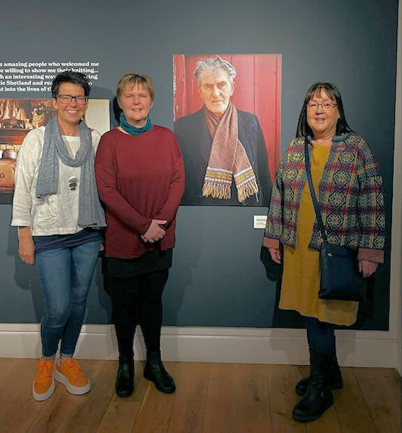 Wendy Inkster, Sharon Deyell and Rachel Robinson beside the photograph of their Grandfather,  Jeemie Ritch from Unst. | Karen Clubb