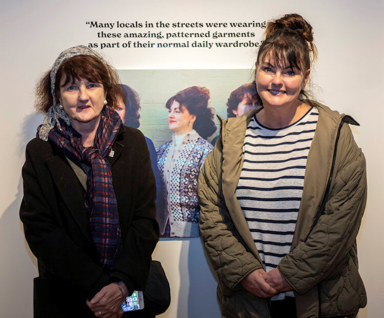 Wendy Lowe and Kathryn Scott beside portrait of mother, Bella Scott. | Alexa Fitzgibbon