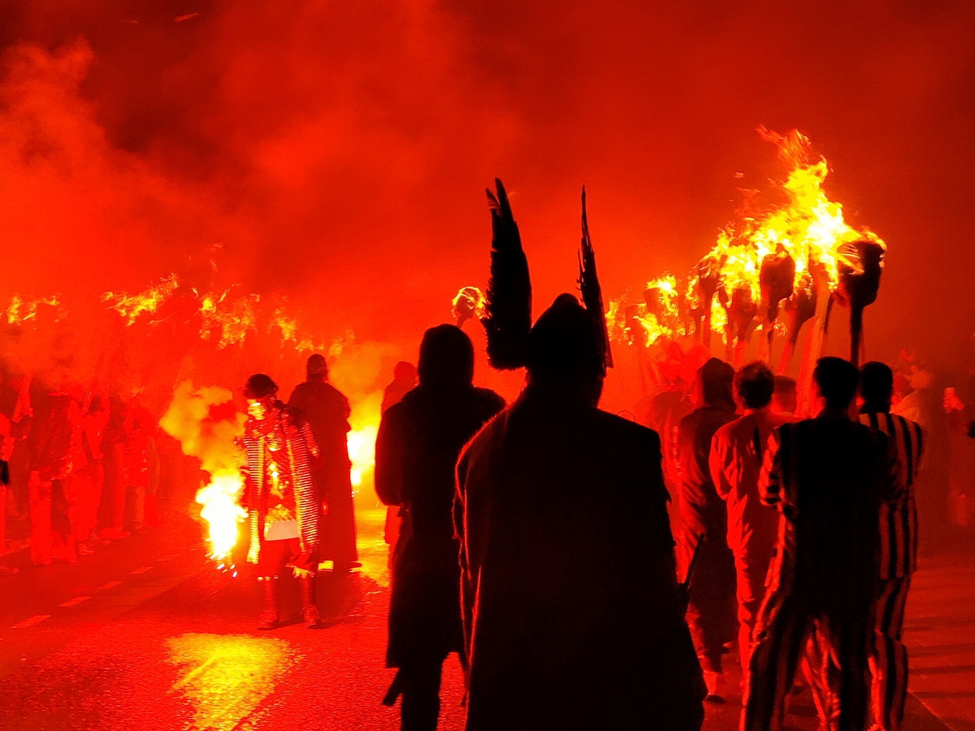 The skies are illuminated by flares and torches as the procession gets ready to begin.