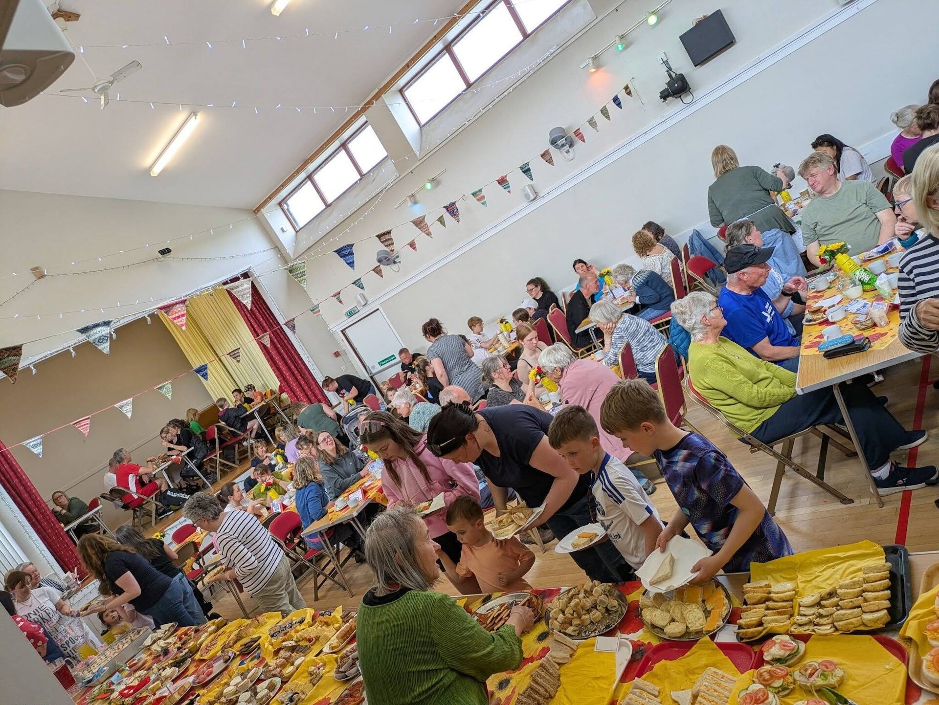Wastside (S)miles Sunday Teas, held in July 2026 &ndash; a lovely example of what makes our Sunday Teas, and our hall, so special.