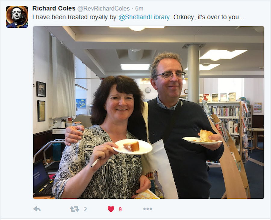 The Reverend Richard Coles enjoys home-baked lemon cake with Library Manager, Karen Fraser, during his visit (Courtesy Rev Richard Coles/Shetland Library/Twitter)