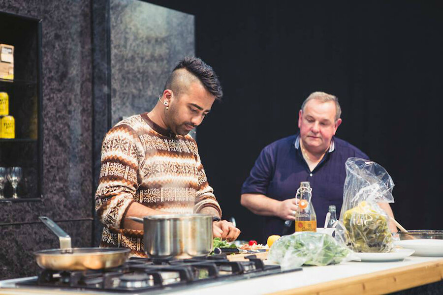 Compere Davie Gardner watches intently as Akshay Borges works on his dish (Courtesy Taste of Shetland)