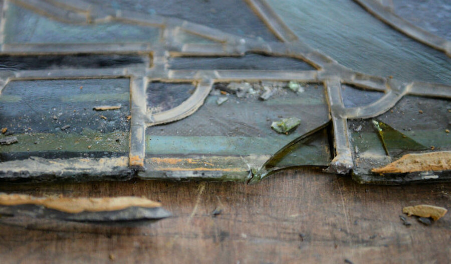 A typical section of a window after removal from the building. The lead edging, with butyl mastic sticking to it, is damaged and a small piece of glass has broken off. (Courtesy Alastair Hamilton)